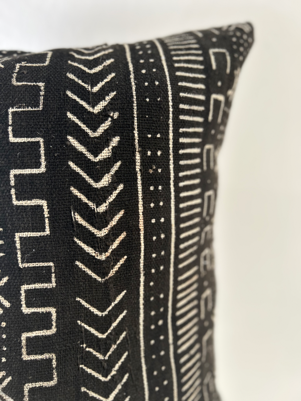 Black and white patterned pillow on a white background