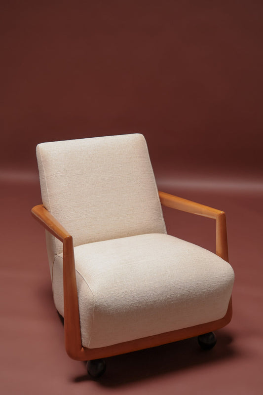 Beige armchair with wooden frame on a brown background