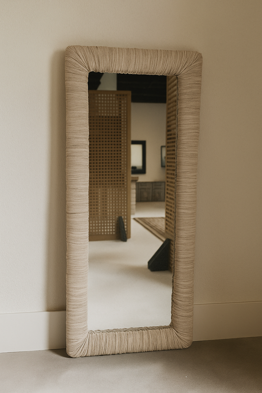 Rectangular mirror with upholstered frame on a plain wall