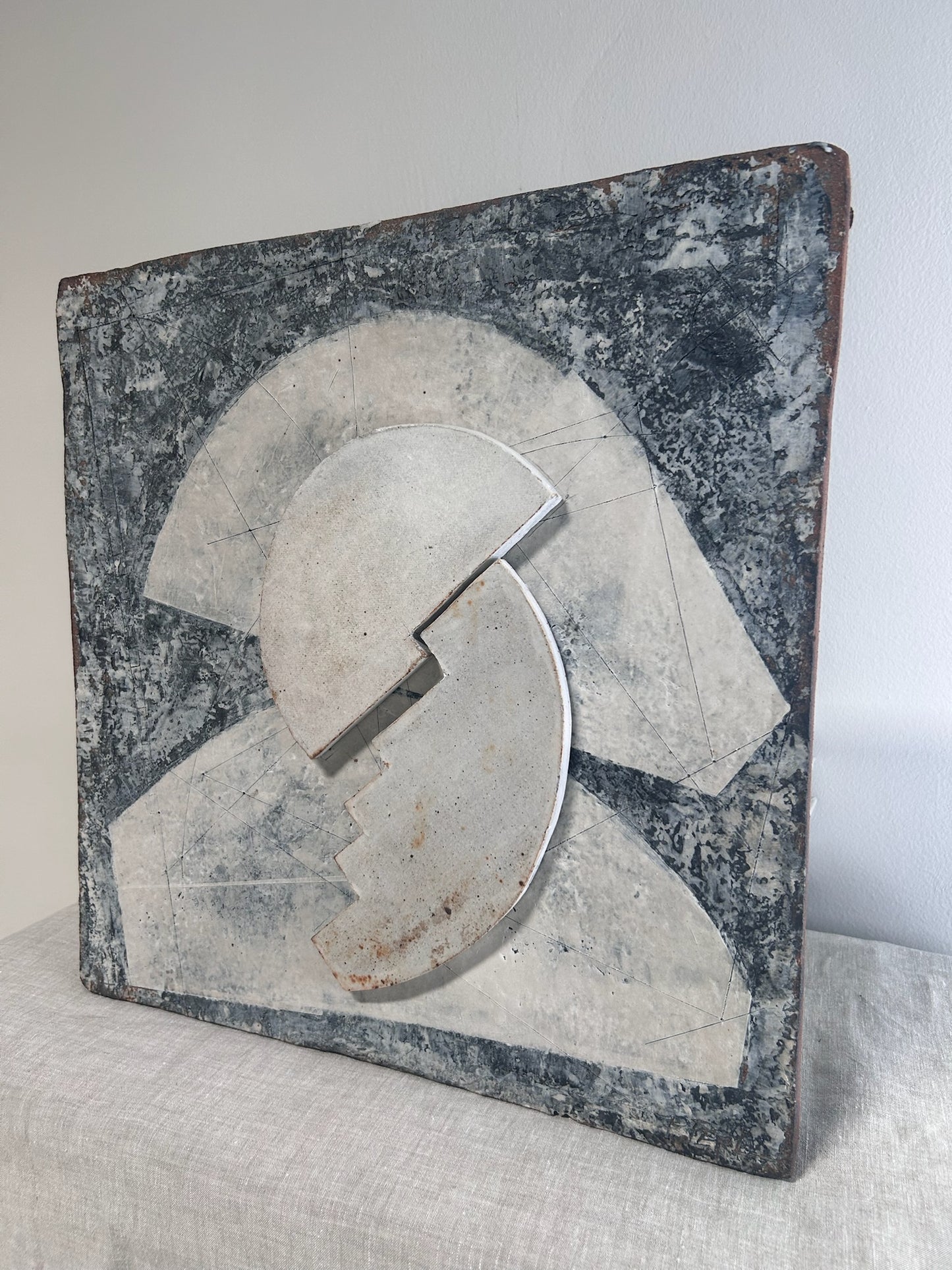 Decorative stone with a broken circle design on a light gray background